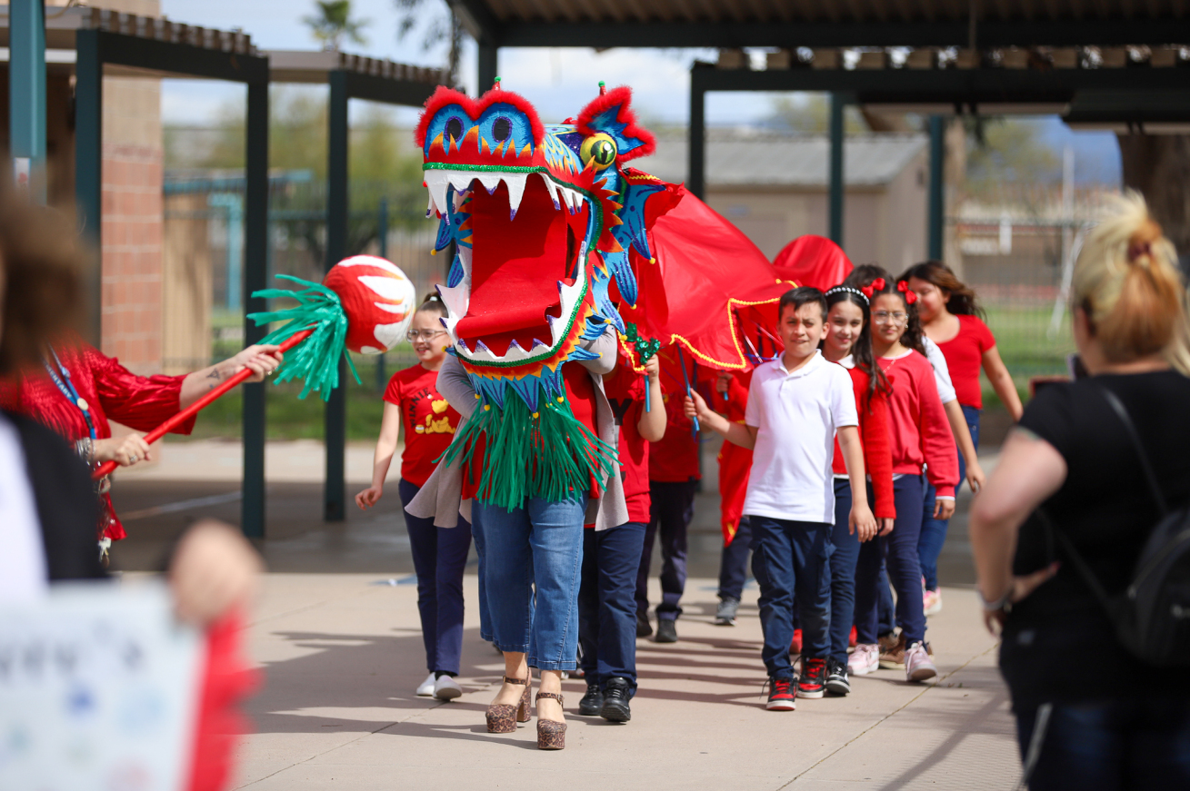 Students in a dragon costume lead the parade