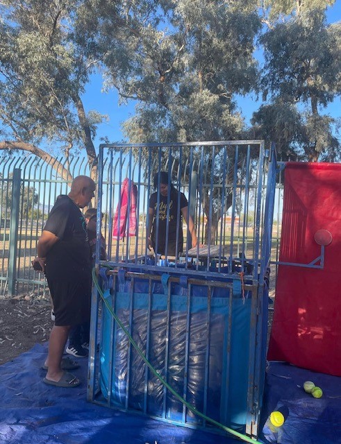 Families check out the dunk tank at the spring festival