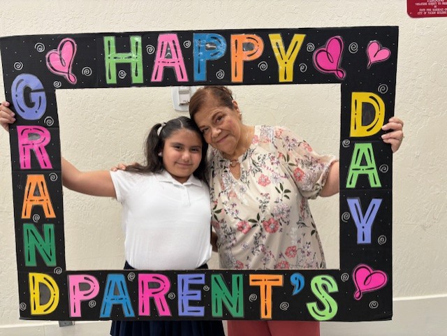 A girl and her grandma smile in the Grandparents Day photo frame